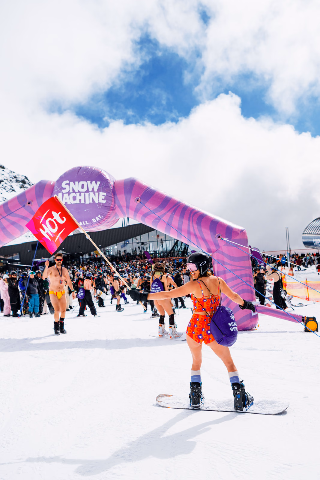 Festival-goer with brand flags on the mountain