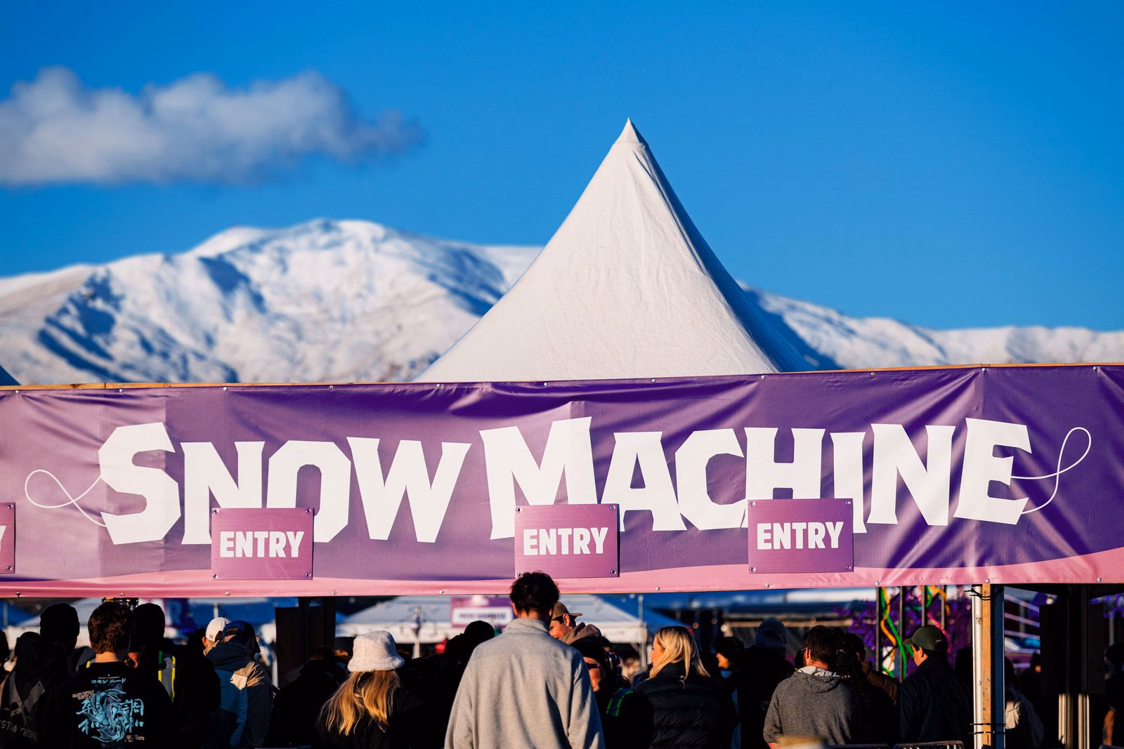 Snow Machine entrance banner with the mountains behind