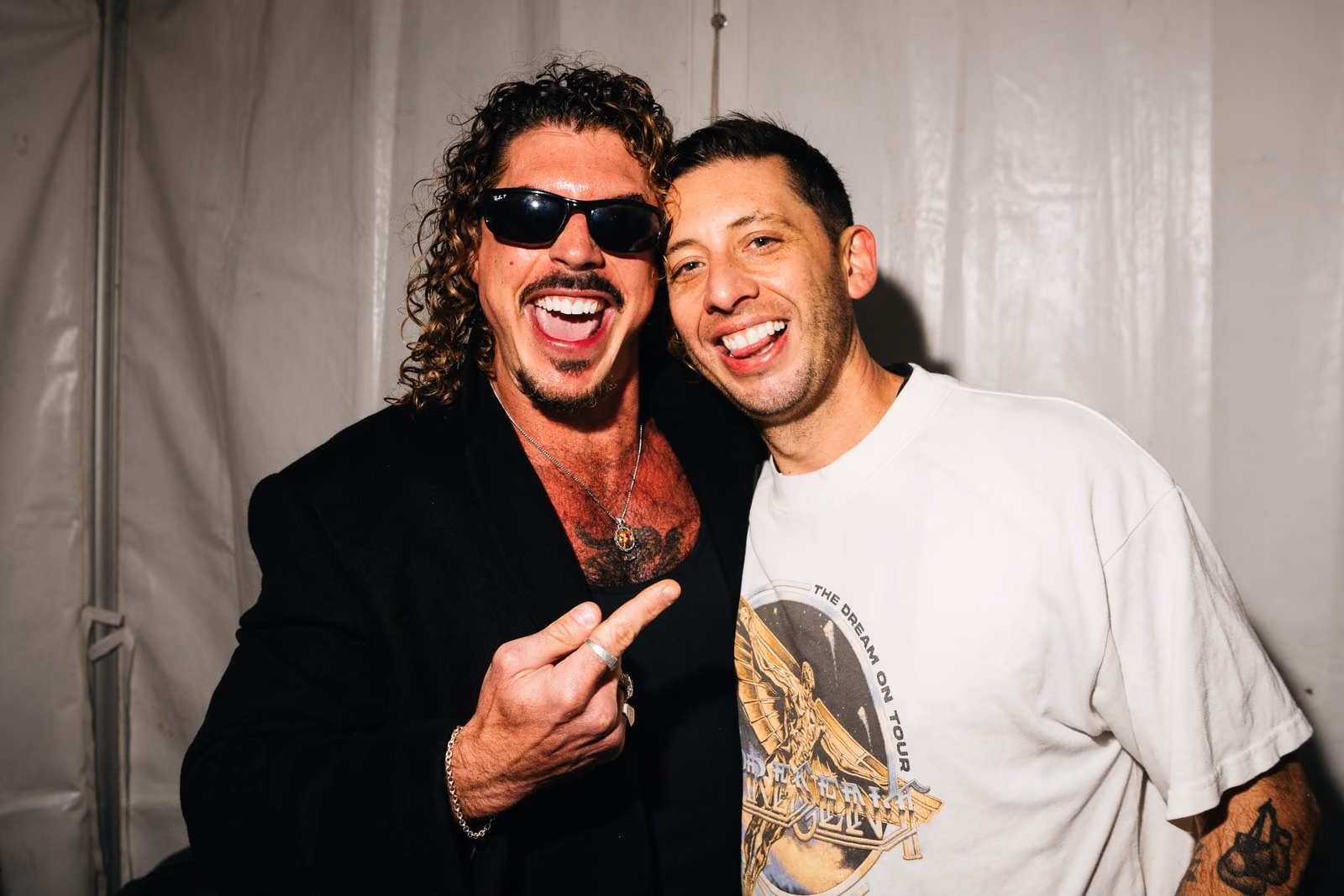 Keli Holiday grinning backstage with a friend