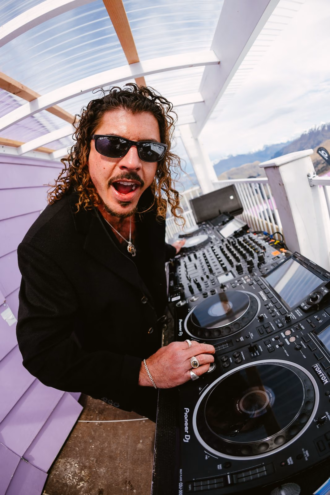 Fisheye shot of Keli Holiday DJing the 2pm Coronet Peak set