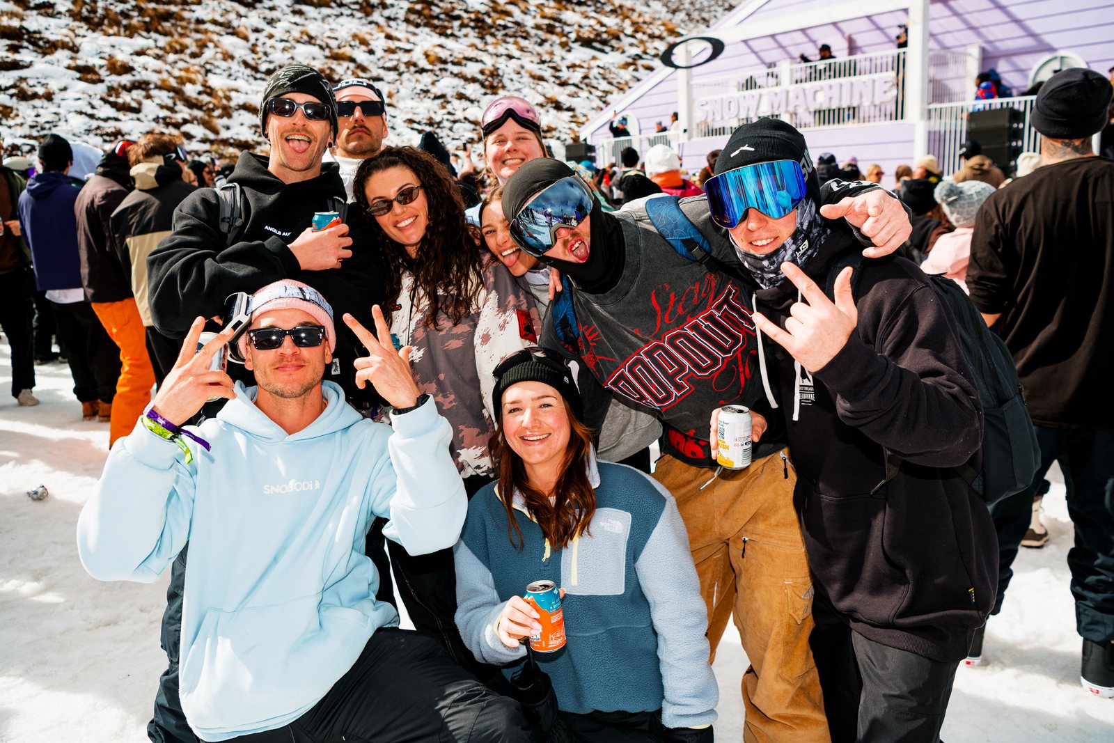 Group of friends in goggles and hoodies celebrating at the Coronet Peak après session